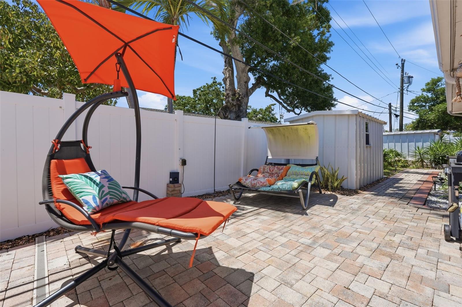 The beautiful paver patio offers additional space for lounging and entertaining outdoors.