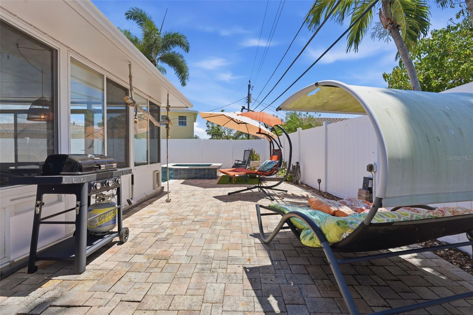 The beautiful paver patio offers additional space for lounging and entertaining outdoors.
