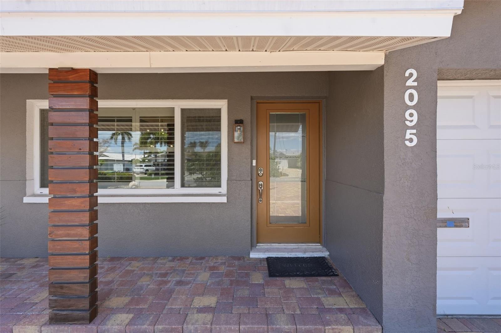 Clean lines, rich wood accents, and modern finishes create a sophisticated first impression before you even step inside.