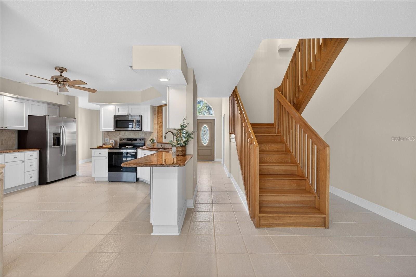 Standing in living room facing foyer and stairs