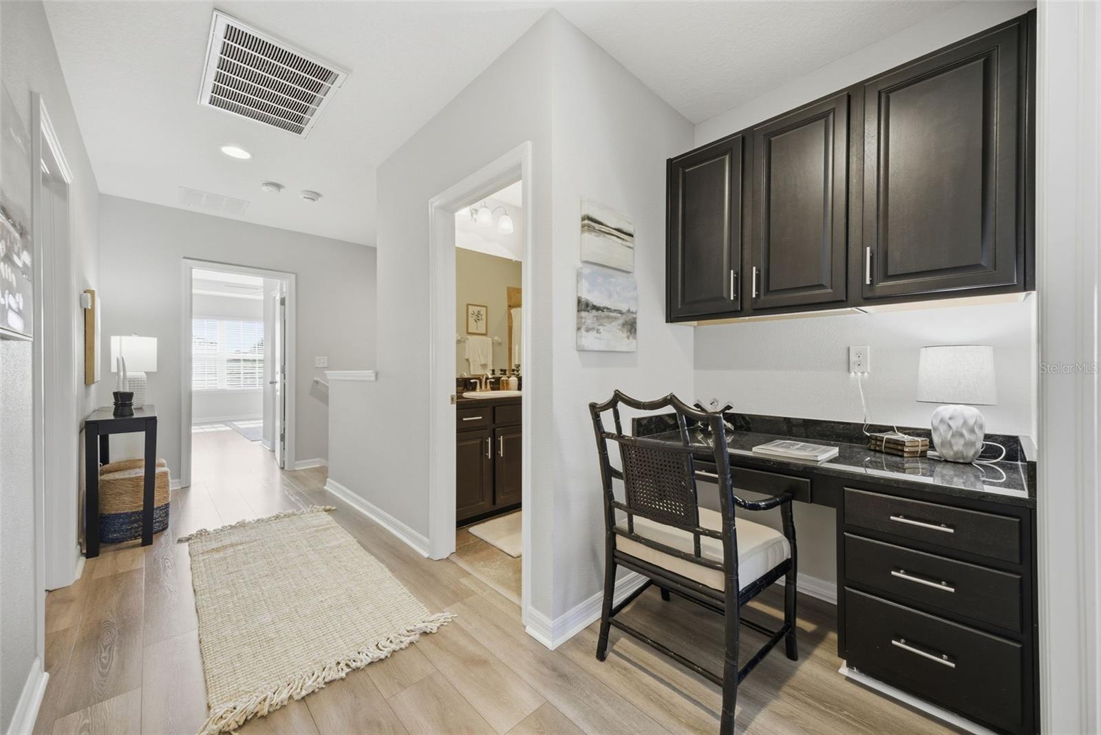 loft has a hall bath and built in workspace