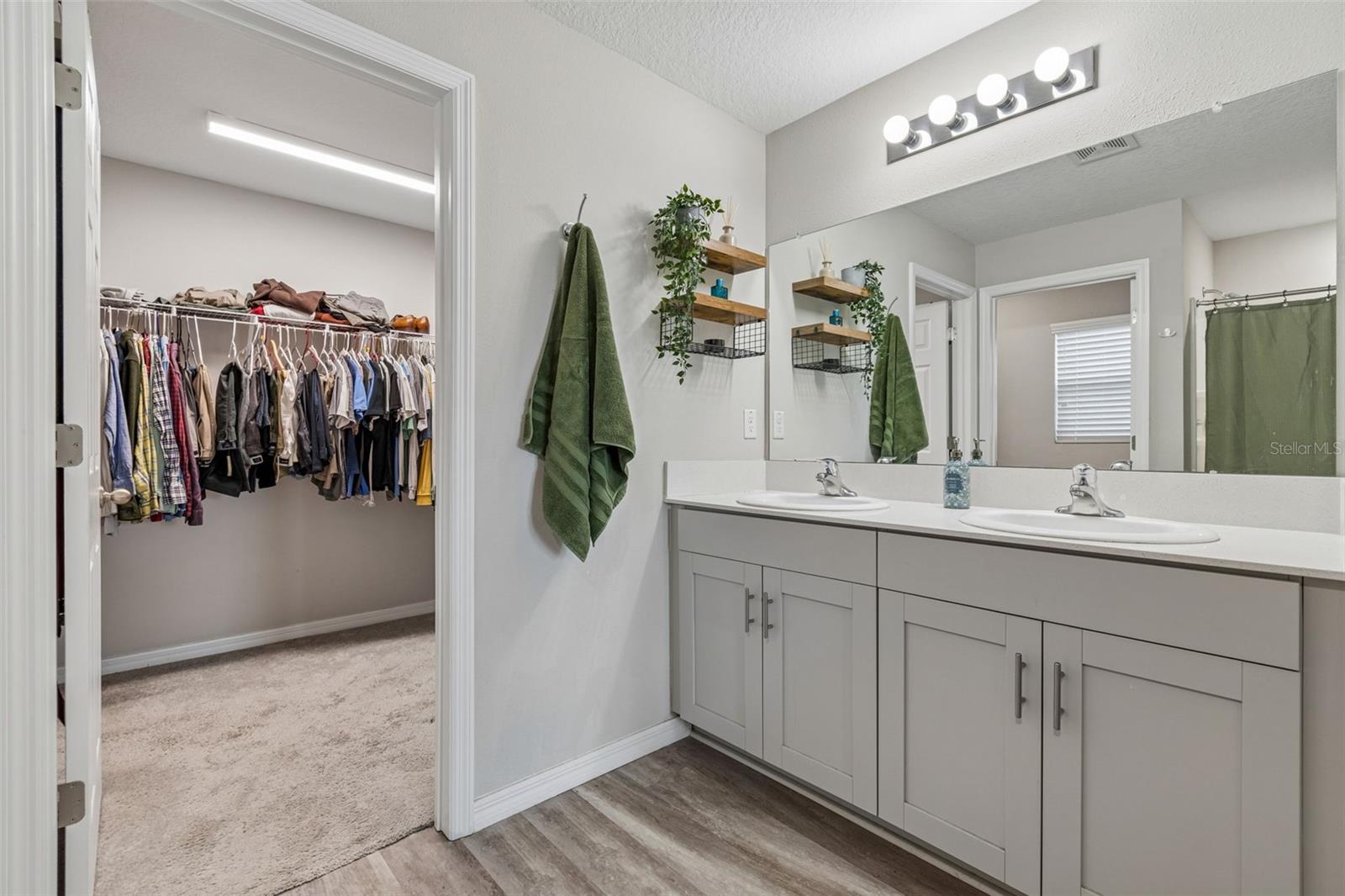 Double vanities with quartz countertops...and a huge walk-in-closet!