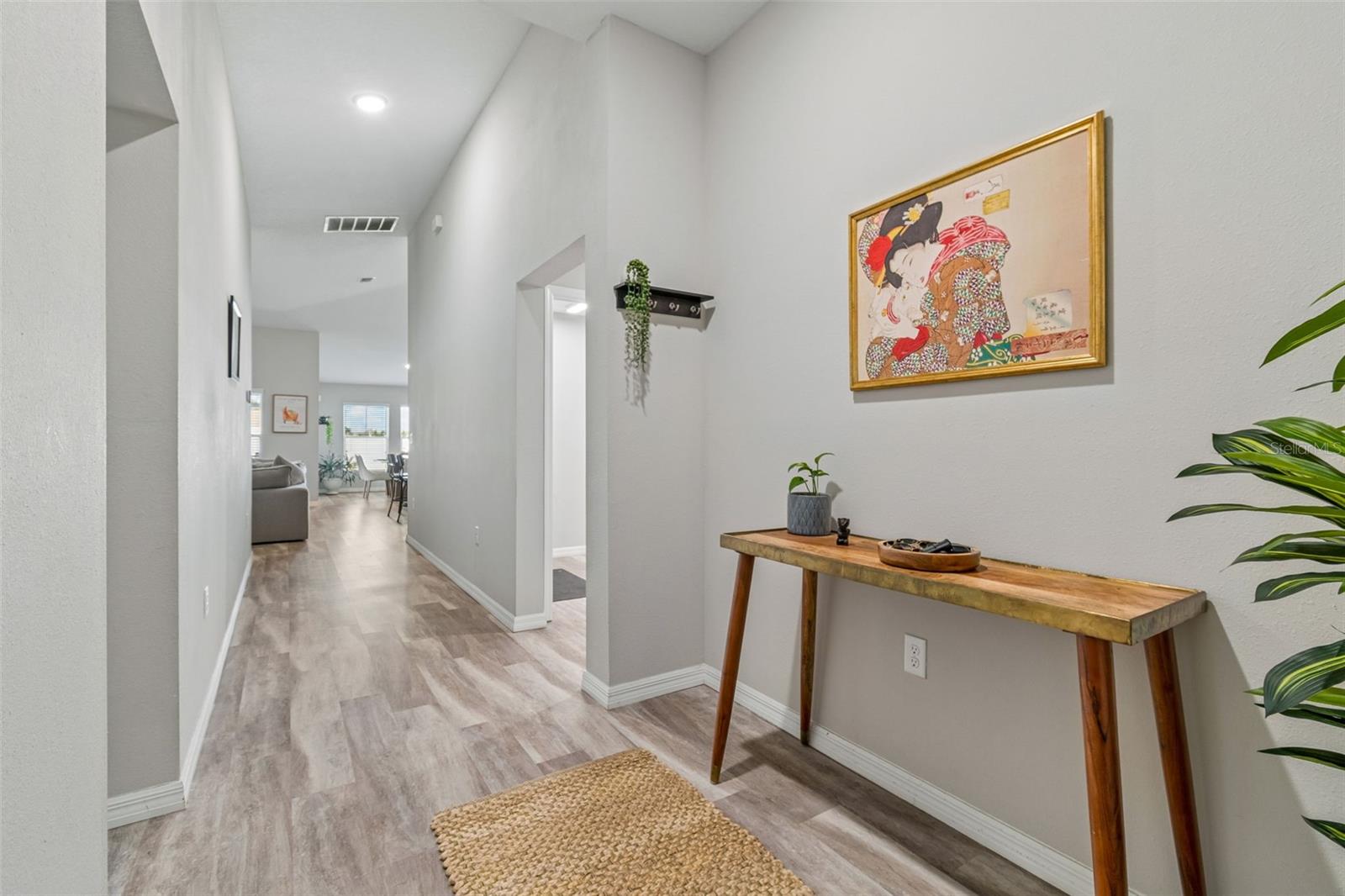 Foyer continues back towards open living, dining and kitchen...