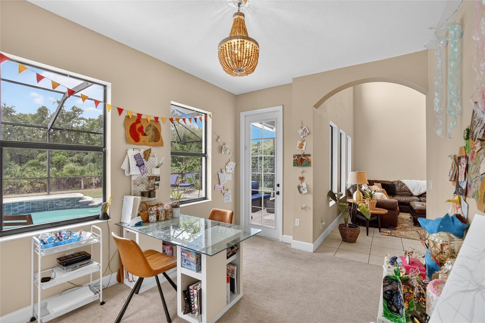 Just off the primary suite is an additional flex space overlooking the pool with direct patio access