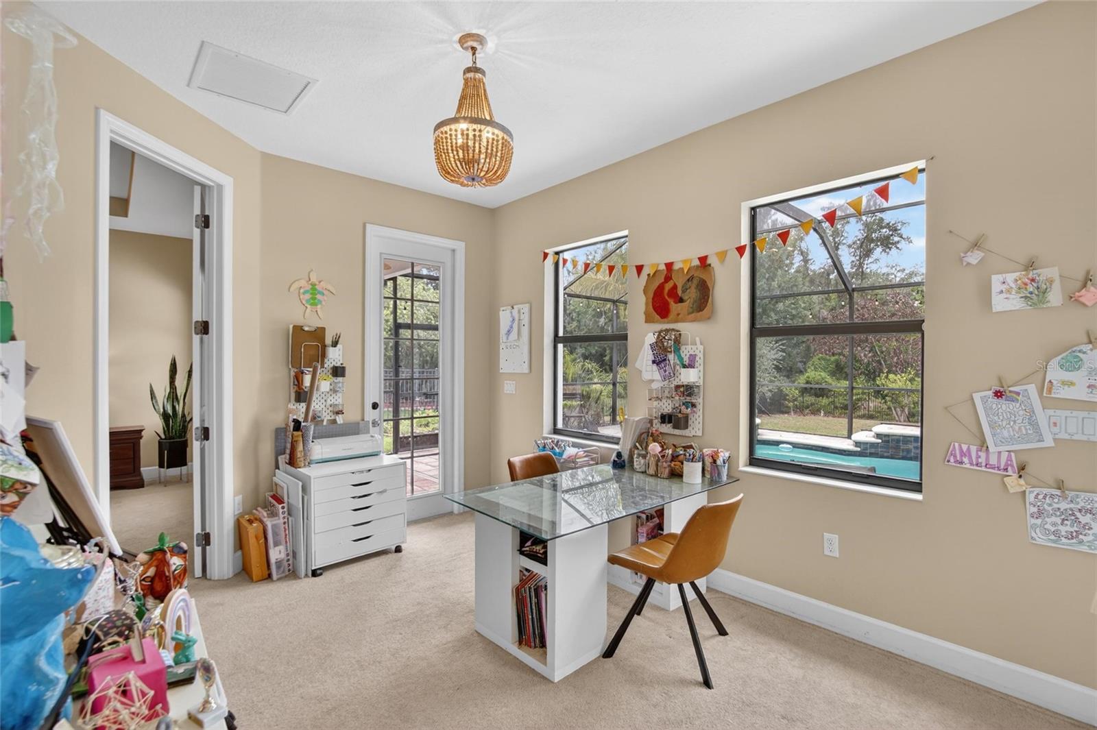Just off the primary suite is an additional flex space overlooking the pool with direct patio access