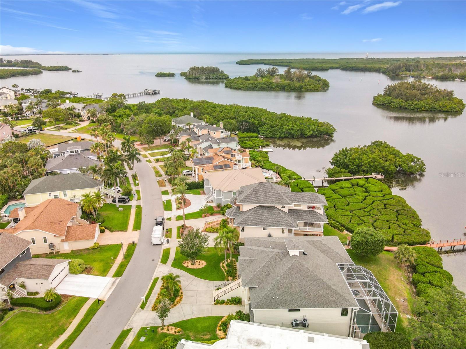 From a bird's-eye view, this aerial footage highlights the home’s prime location with effortless access to the intercoastal, surrounded by stunning natural beauty. Just a short journey away, the open Gulf awaits, promising endless adventures and serene waters.