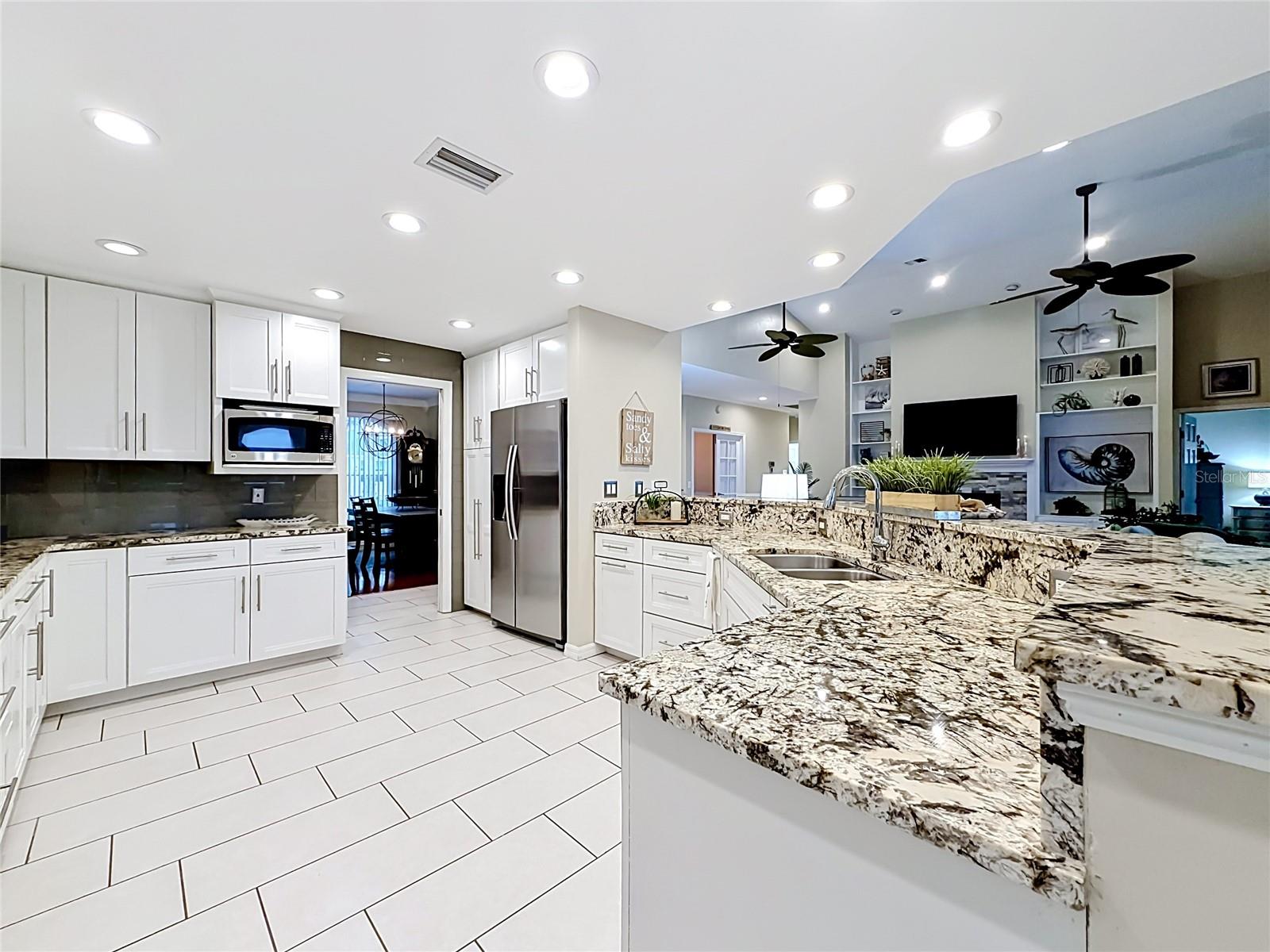 Brilliant white surfaces and gorgeous quartz countertops blend with functional elegance