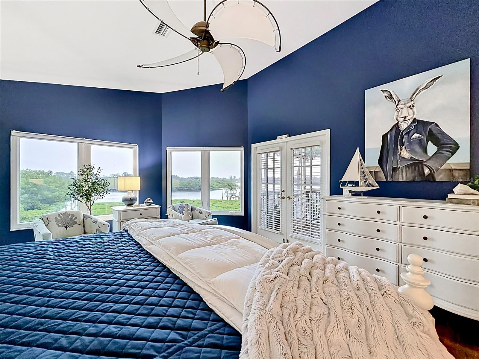 Every morning feels special in this spacious primary bedroom, where magnificent views of the intercoastal inspire a pinch-me moment in your own piece of paradise
