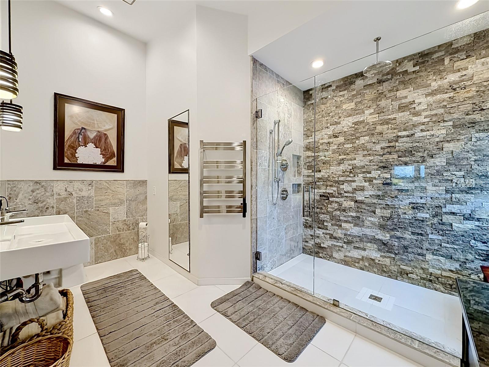 Indulge in luxury in this primary ensuite, featuring a custom rain shower that elevates your daily routine—an elegant retreat that embodies the essence of intercoastal living.