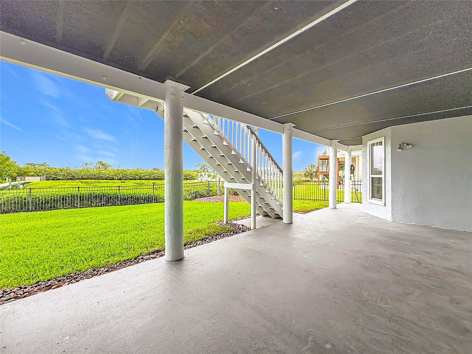 This spacious lower-level patio offers the ideal setting for outdoor dining, cozy gatherings, or simply unwinding on the porch swing amidst refreshing views.