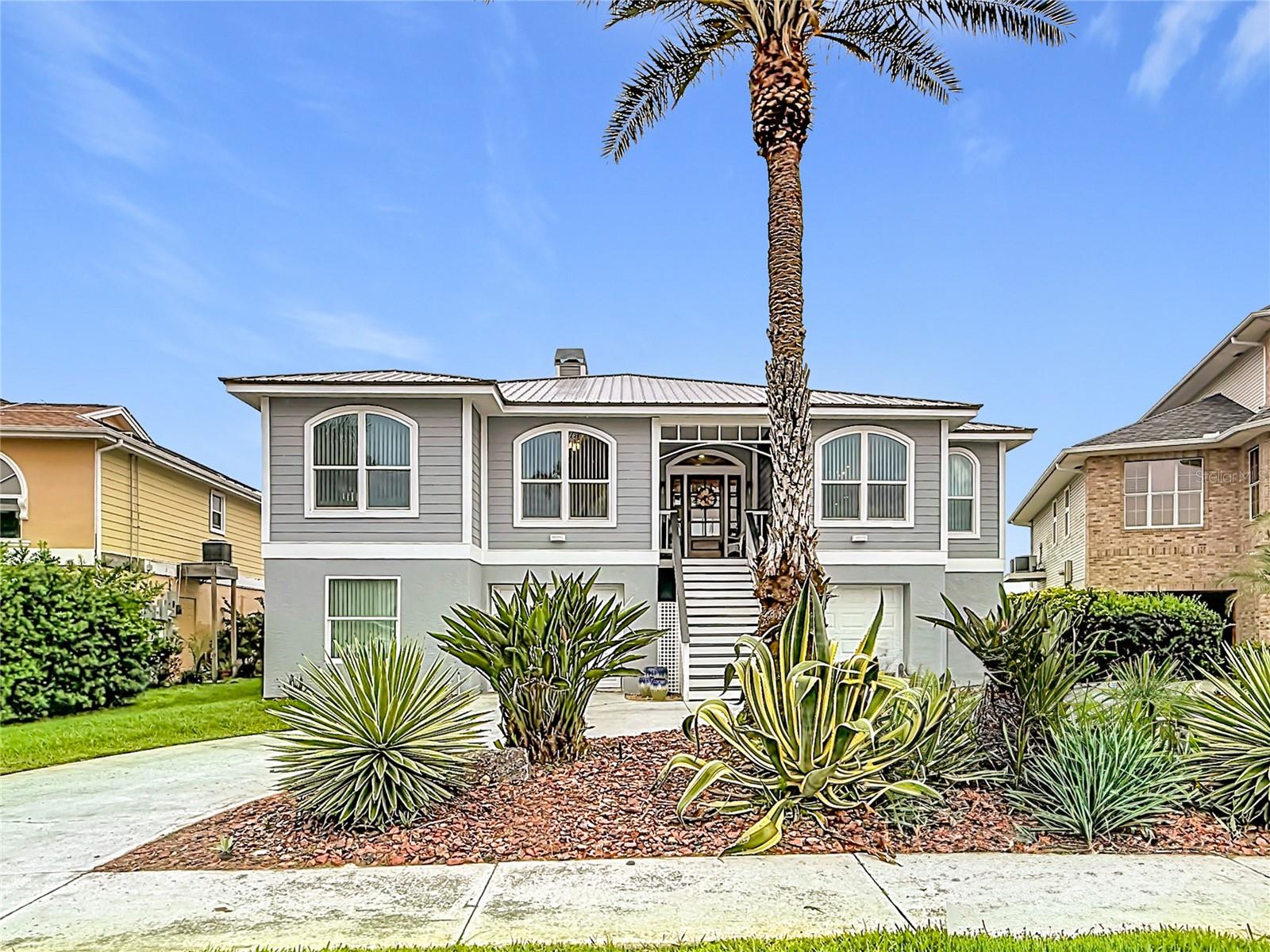 Discover exceptional curb appeal in this stunning waterfront home, designed for coastal living with professionally landscaped gardens and ample parking for all your guests.