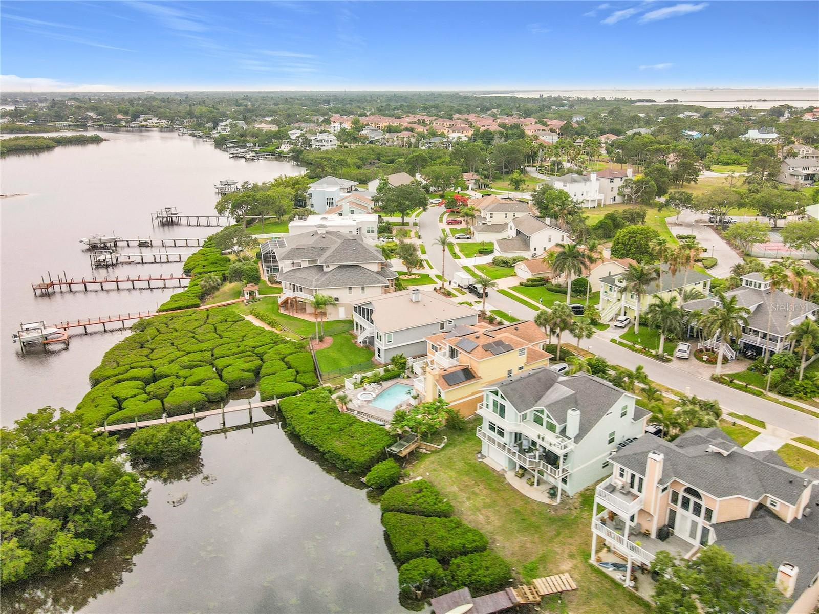 Elevated above the beauty, this drone shot presents a captivating perspective of the waterfront home, framed by flourishing mangroves and the tranquil waters—nature’s masterpiece at its finest.