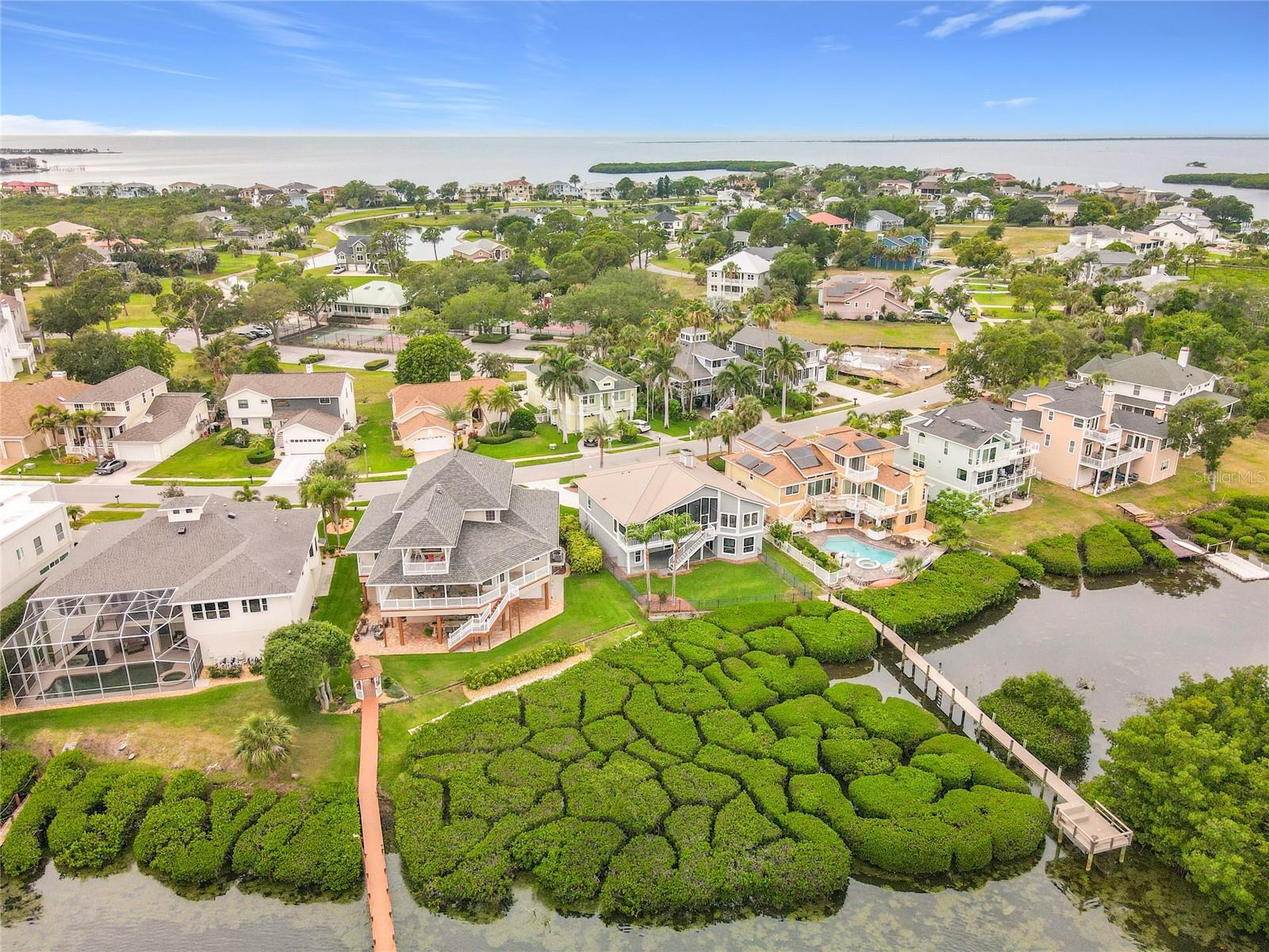 Get a bird's-eye view of this beautiful waterfront property, harmoniously surrounded by vibrant mangroves—an idyllic escape that embodies the tranquility of life by the water.
