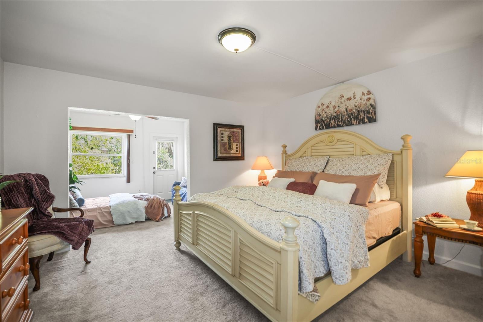 Large primary bedroom with tall ceilings