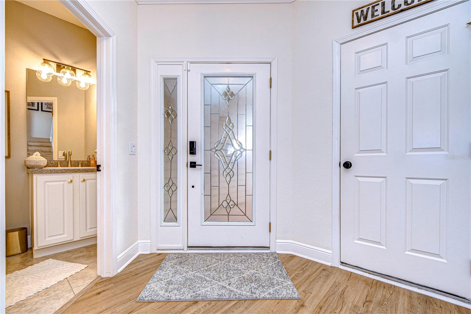 Bright and inviting entry showcasing thoughtful upgrades throughout.