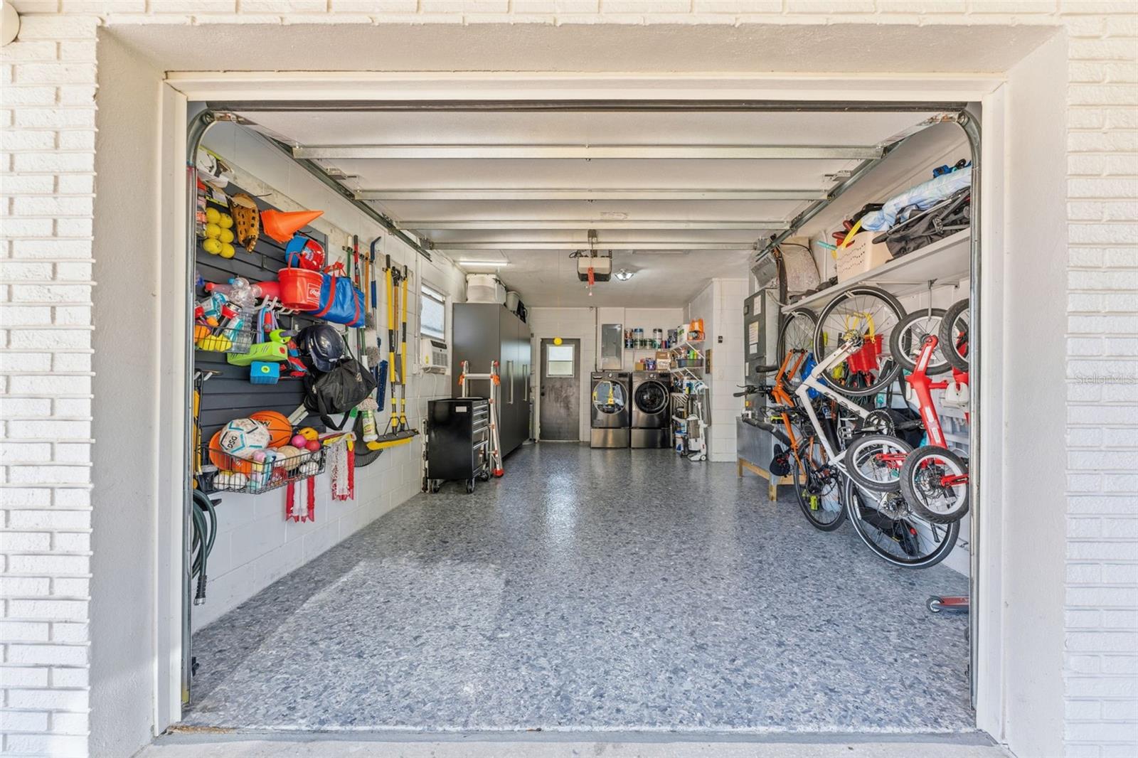 Garage with epoxied floors, storage and your laundry