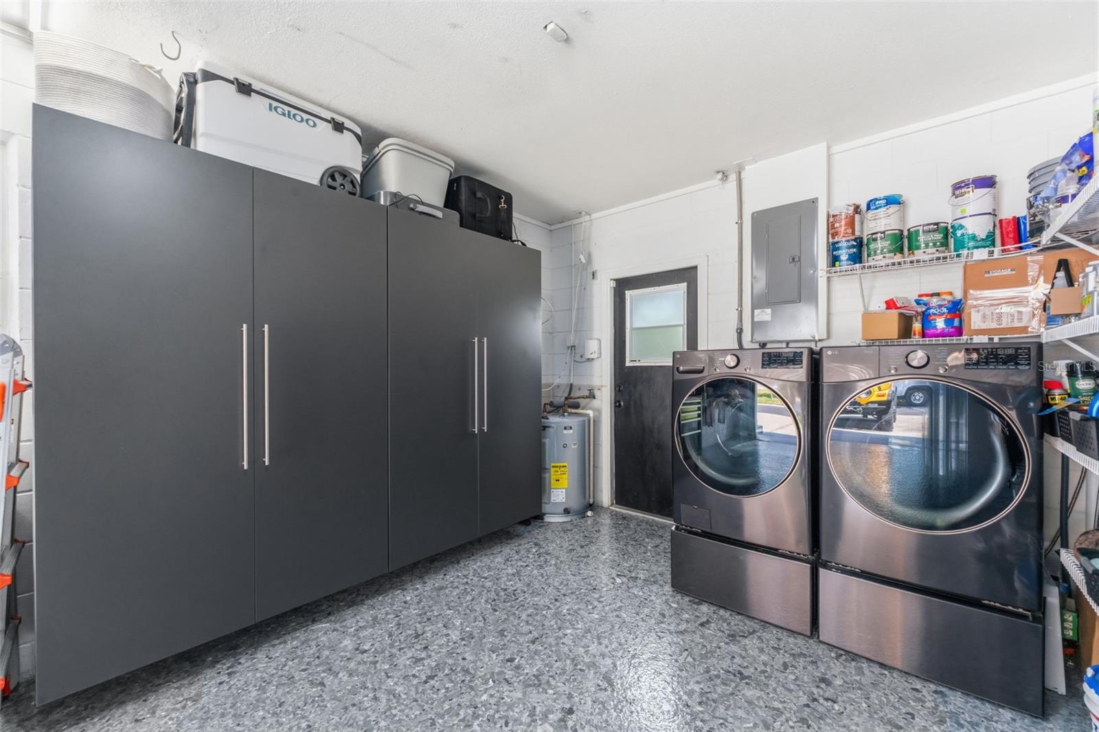 Garage with epoxied floors, storage and your laundry