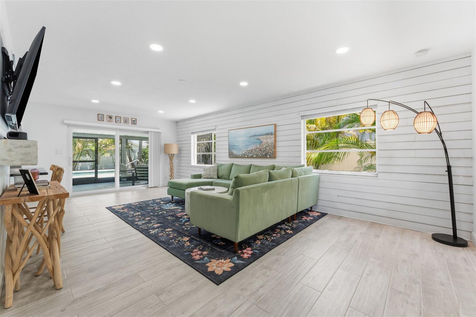 Clean coastal vibes and views of the sparkling pool once you step inside