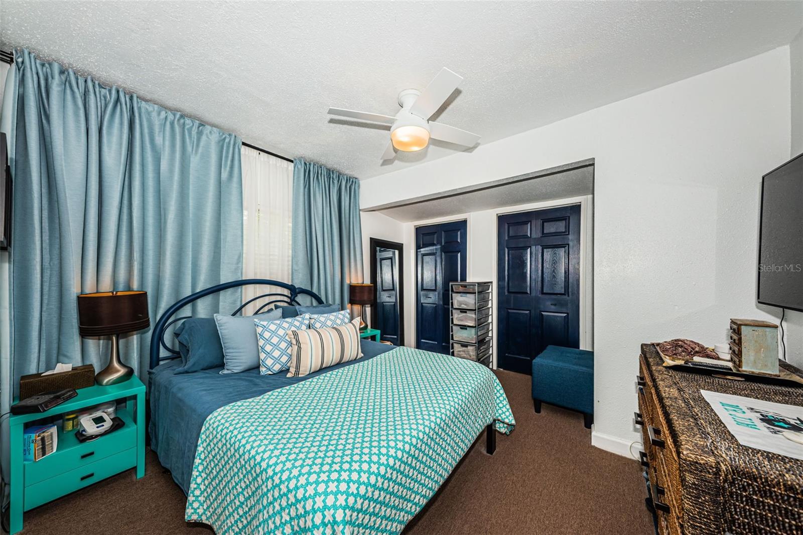 Primary bedroom with a wall of closet