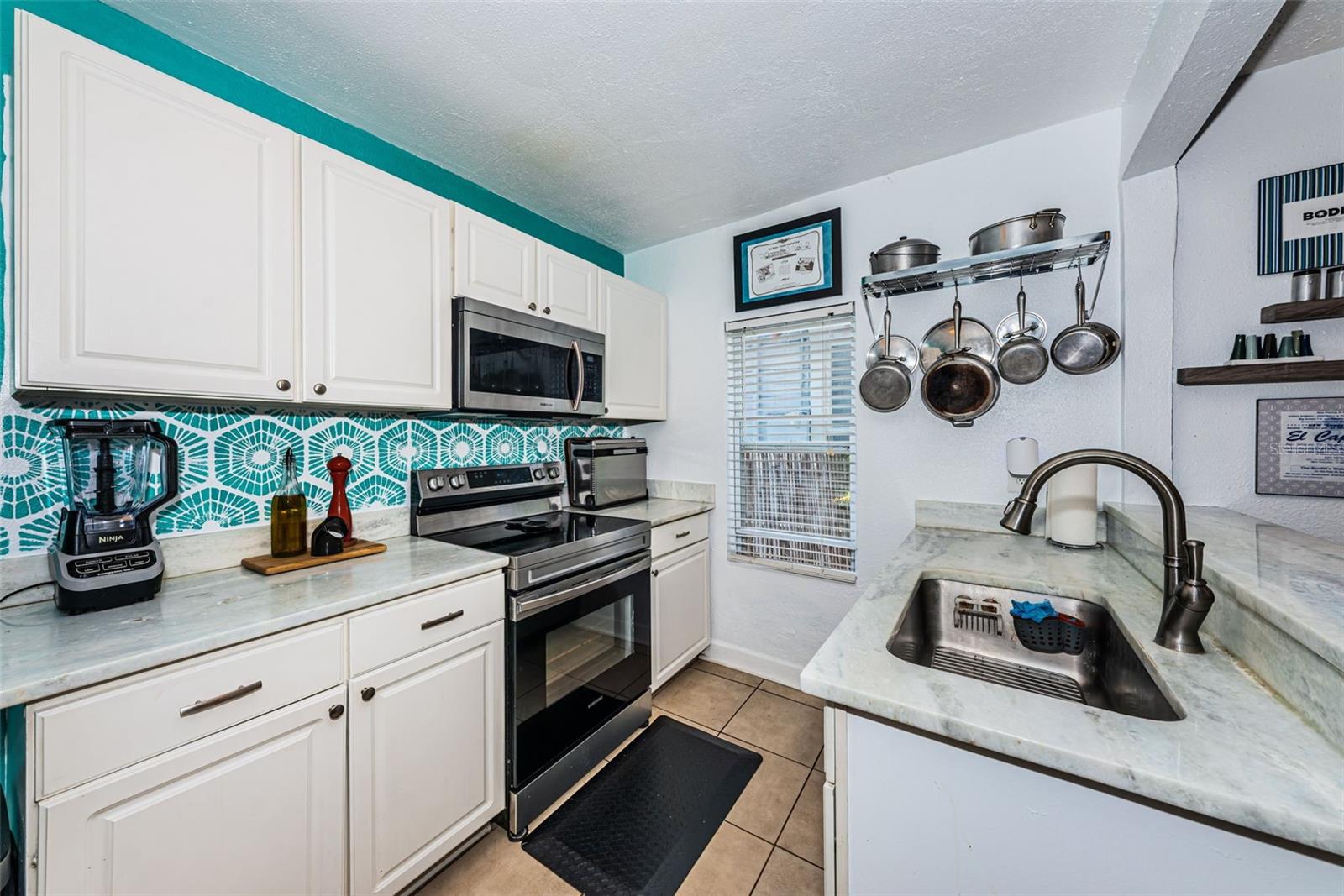 Updated kitchen with stainless steel appliances, and  granite counters