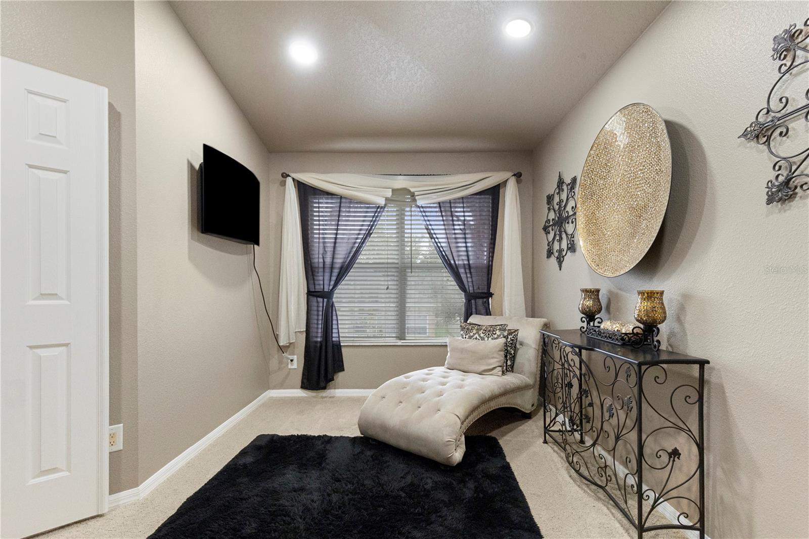 Primary Suite with sitting area, walk-in closet with closet system, and ensuite