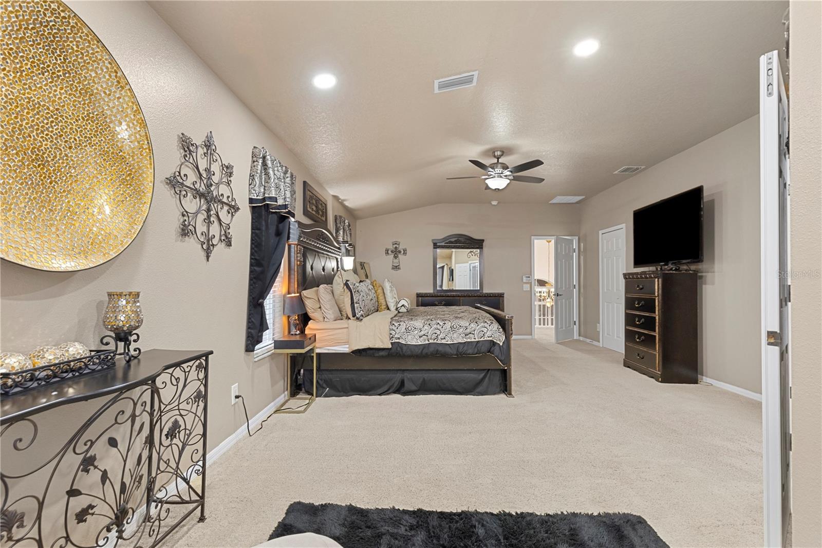 Primary Suite with sitting area, walk-in closet with closet system, and ensuite