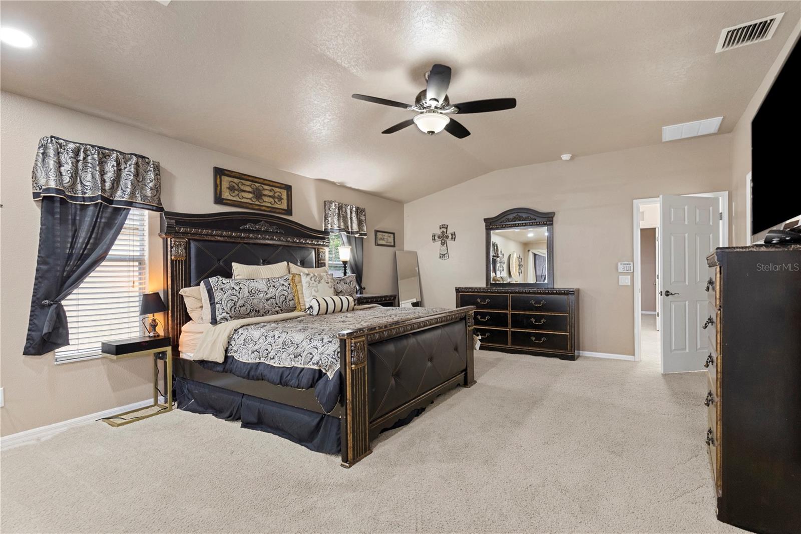 Primary Suite with sitting area, walk-in closet with closet system, and ensuite