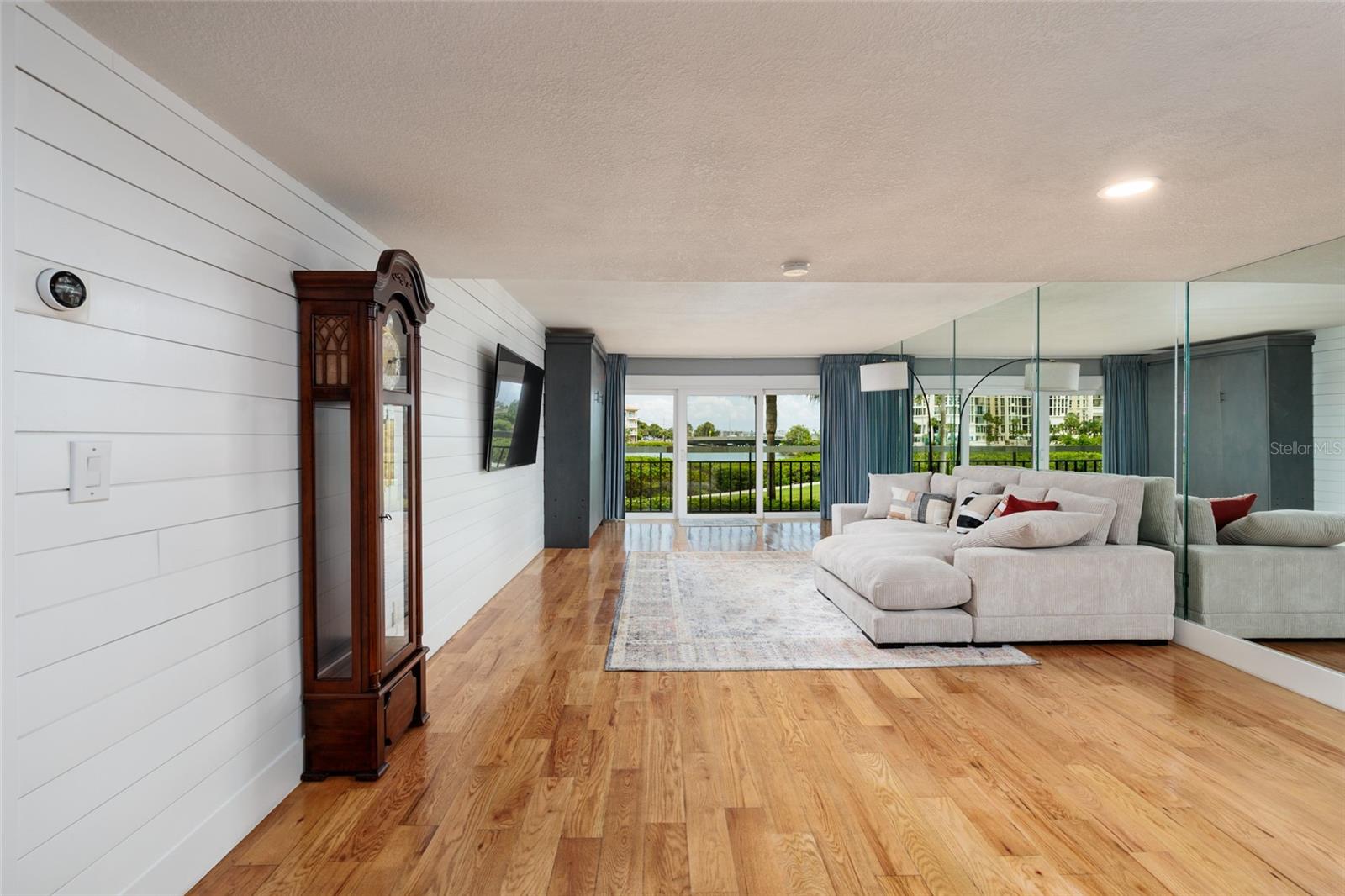 Dining area and living room with wall mounted 70" TV and Murphy bed (no mattress) that can be converted to storage cabinet if desired.  Beautiful engineered hardwood flooring.