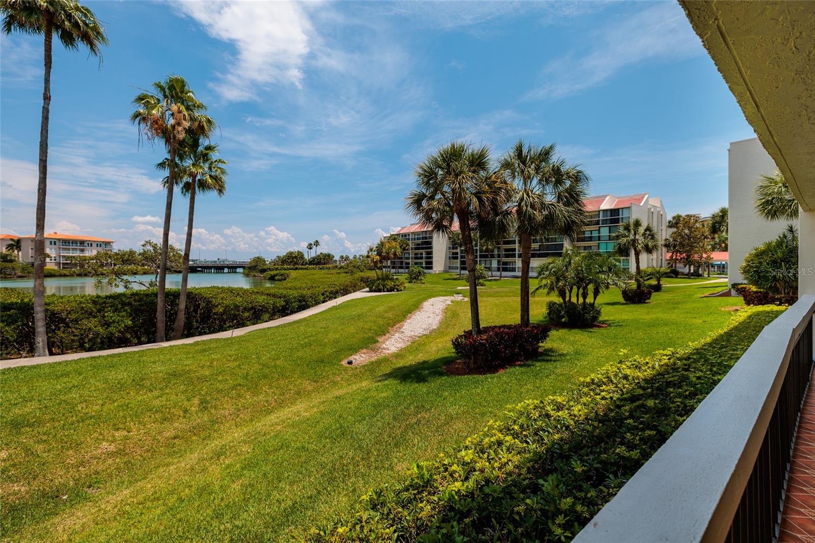 Porch view of the landscaping, walking trail and water basin