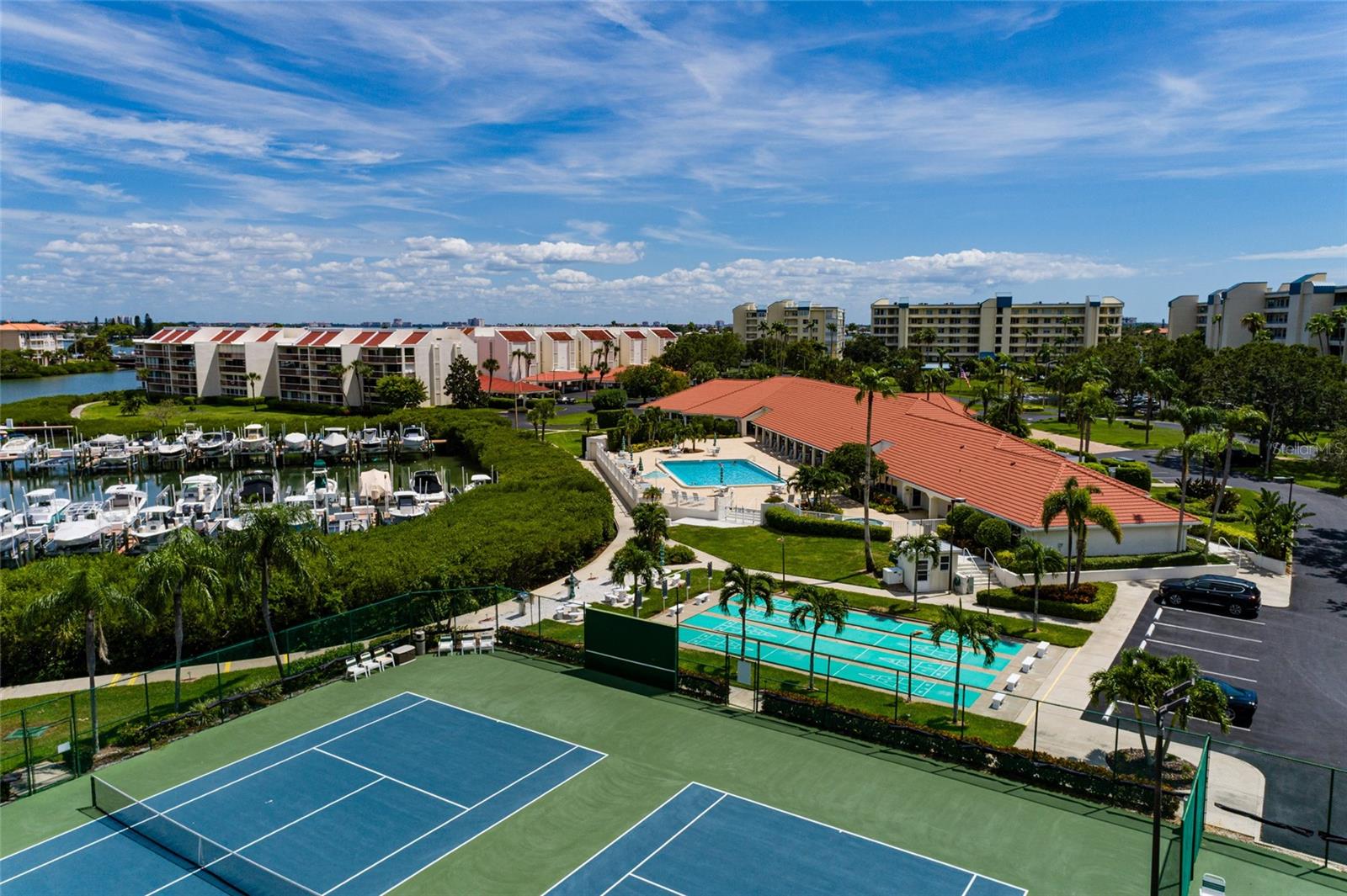 Area view of community center, tennis courts, mrina.