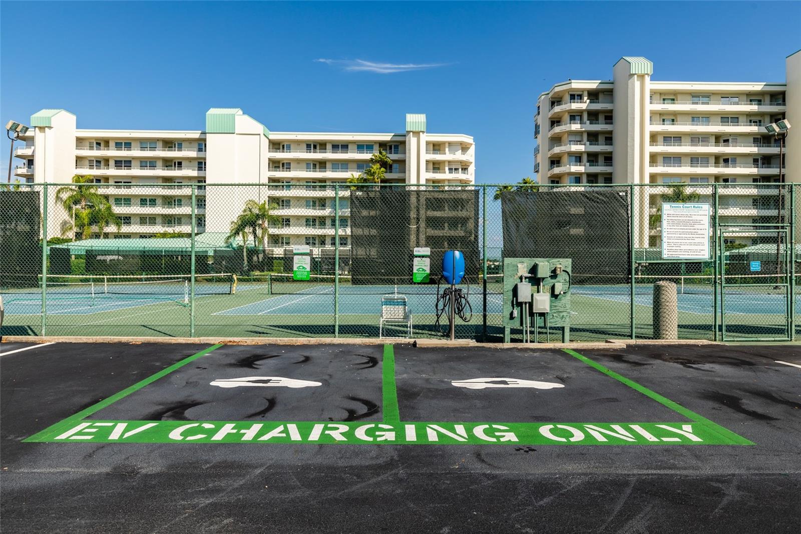 EV charging by tennis courts at community center. Car washing area close by