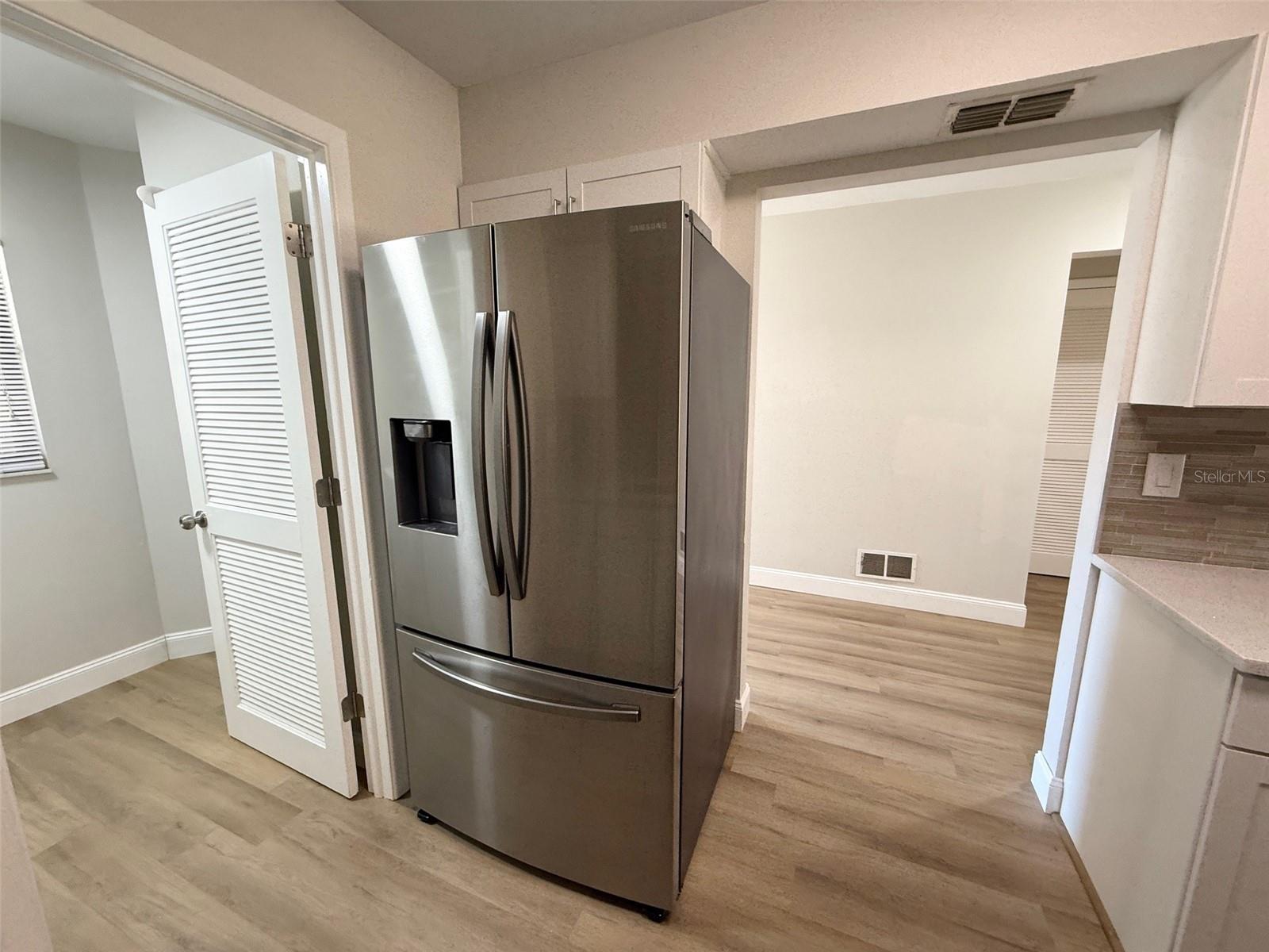Kitchen showing door to laundry and front hallway