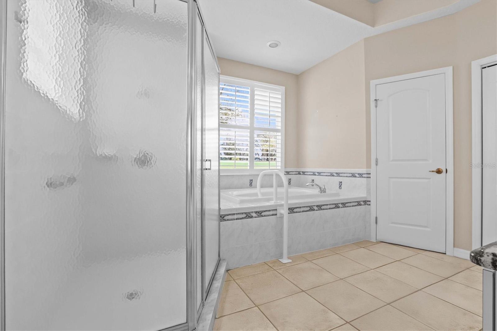 Primary Bathroom with Tub and Walk In Shower