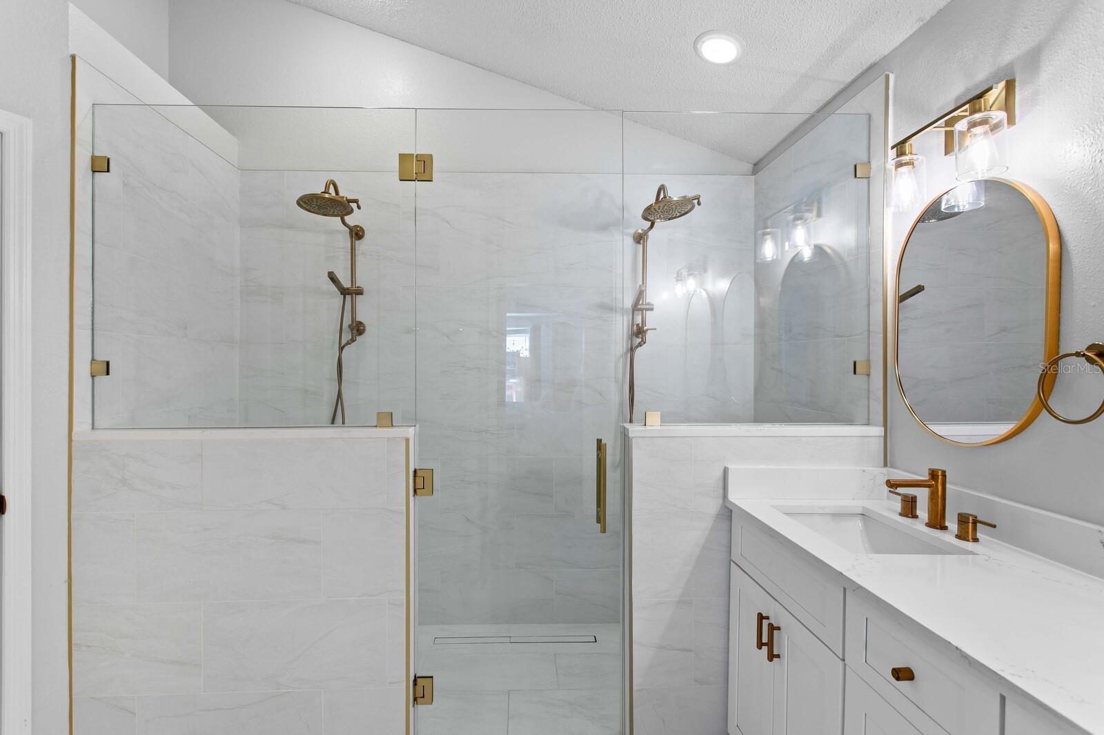 Custom walk-in shower with dual rainheads and digital controls