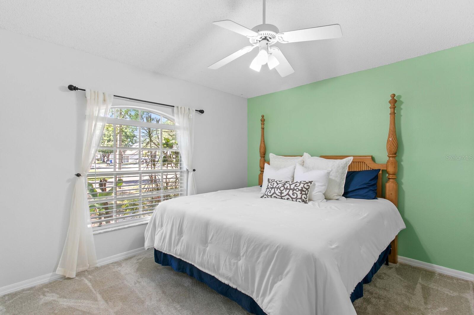 2nd bedroom at front of home with vaulted ceilings
