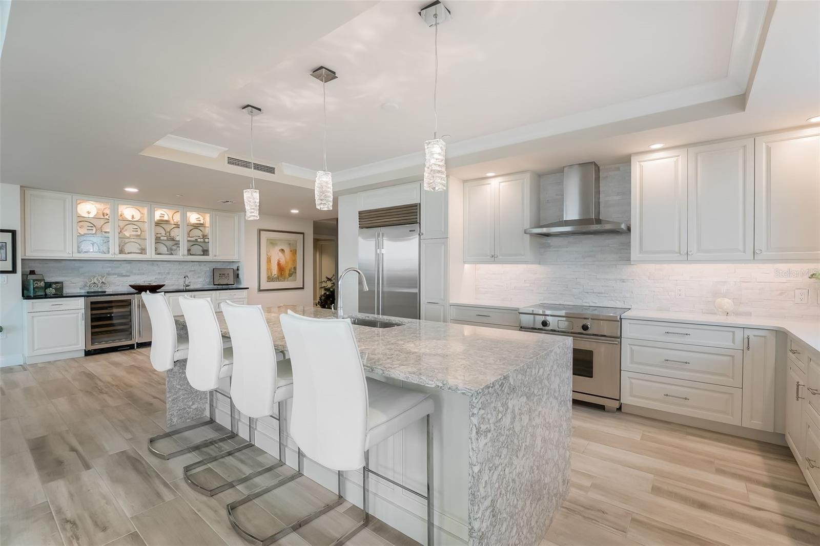 Great kitchen layout with wine refrigerator & wet bar plus breakfast bar/kitchen island