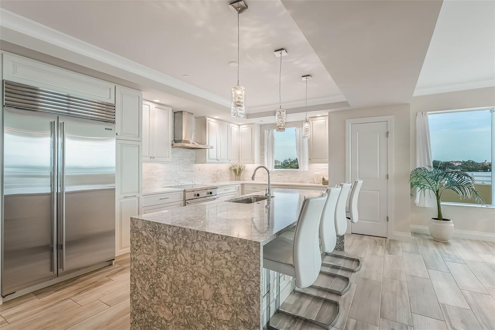 Notice that the kitchen island has seating for 4 and there is a closet pantry plus a sub-zero refrigerator/freezer.