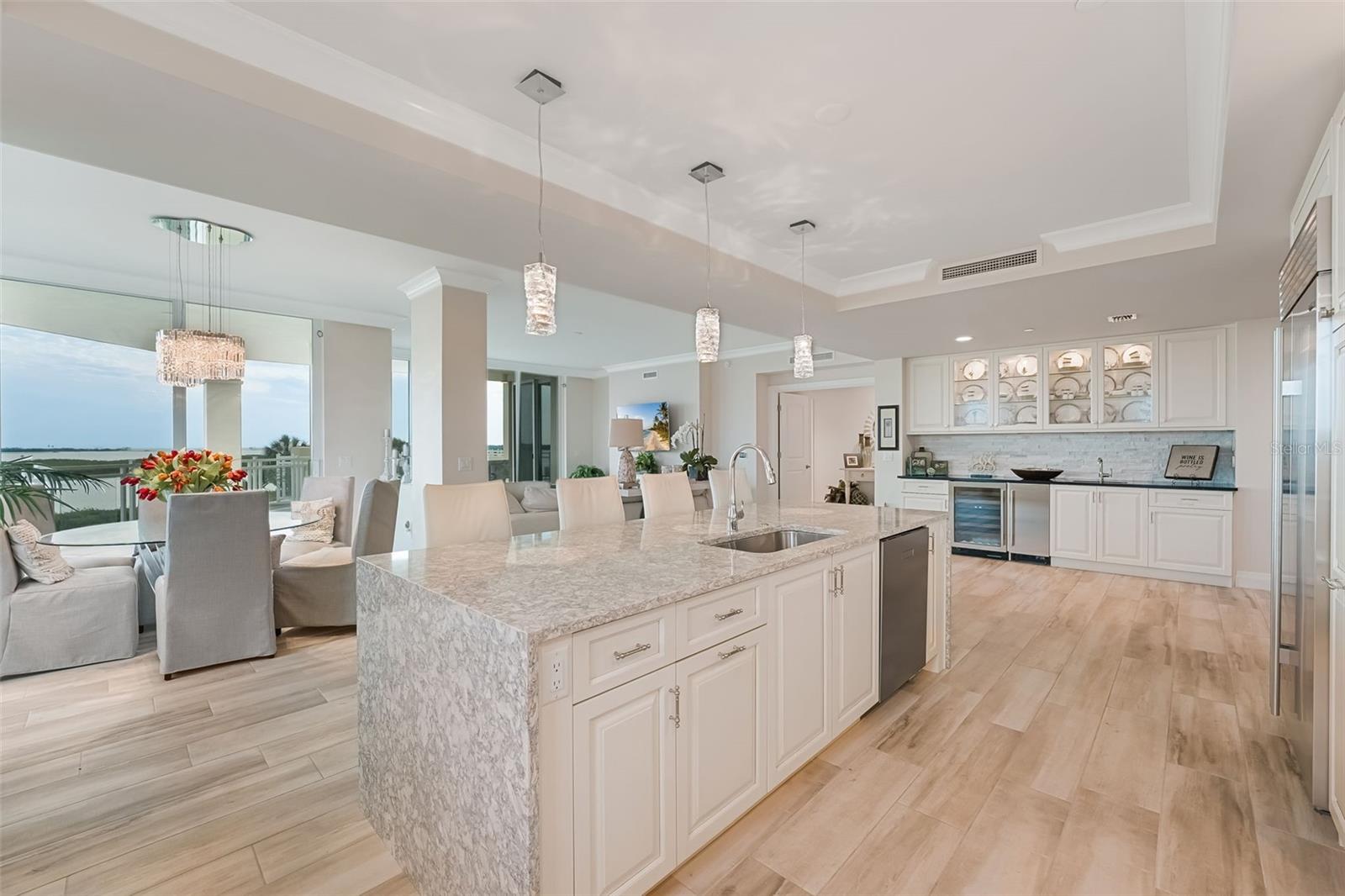 A great overview of your living area - showing the wet bar area, kitchen island and dining area