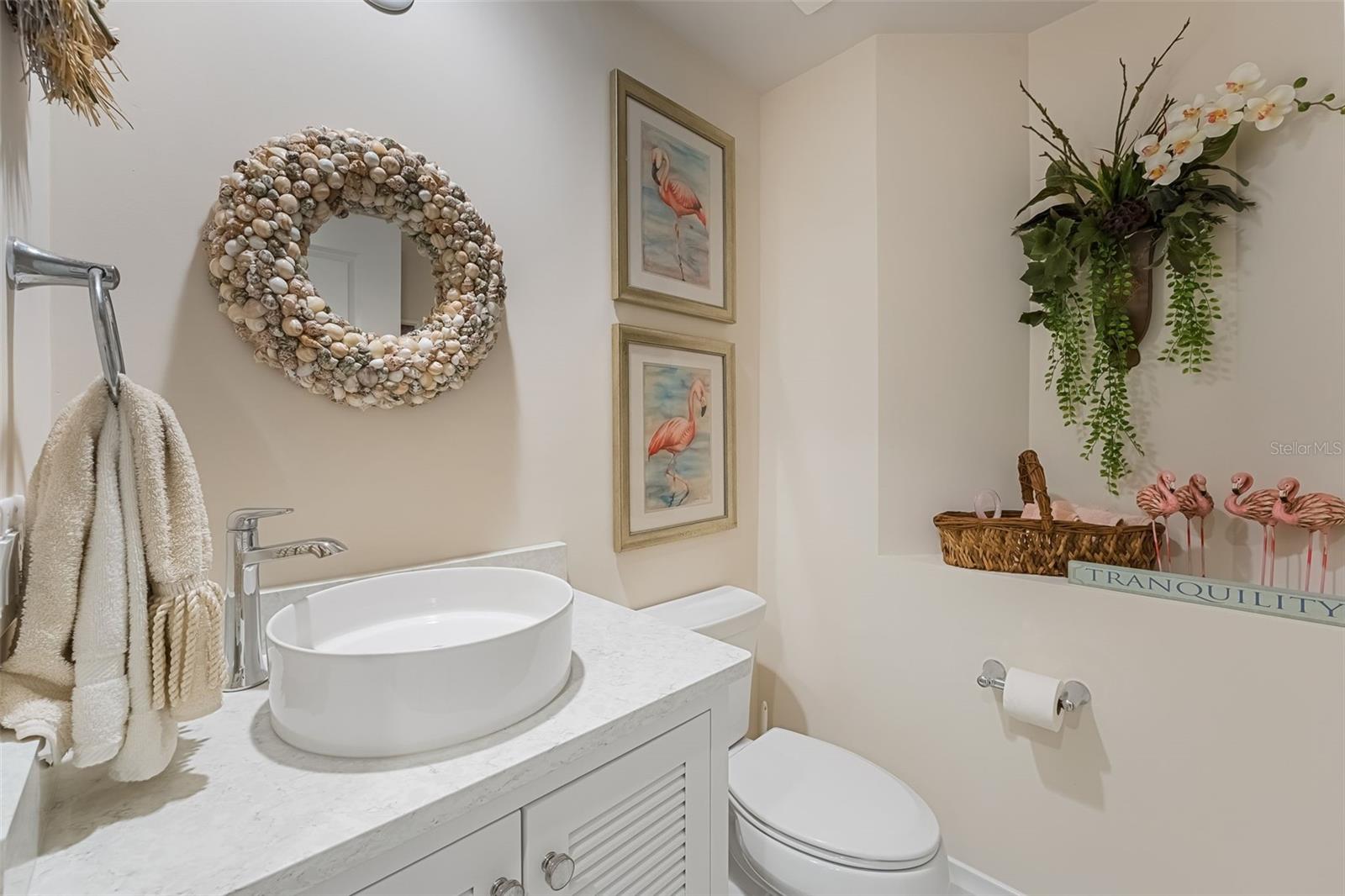 This is the half bath for guests - nicely done with coastal decor