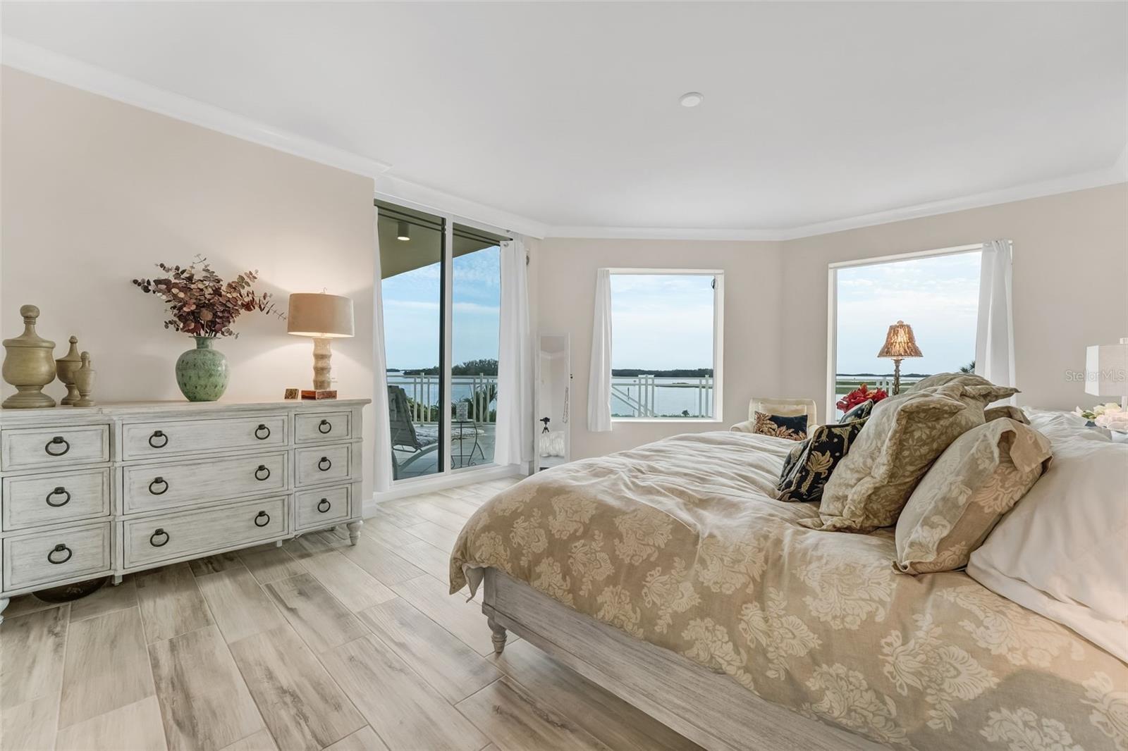 Primary bedroom view with sliders to the balcony and magnificent views of the water