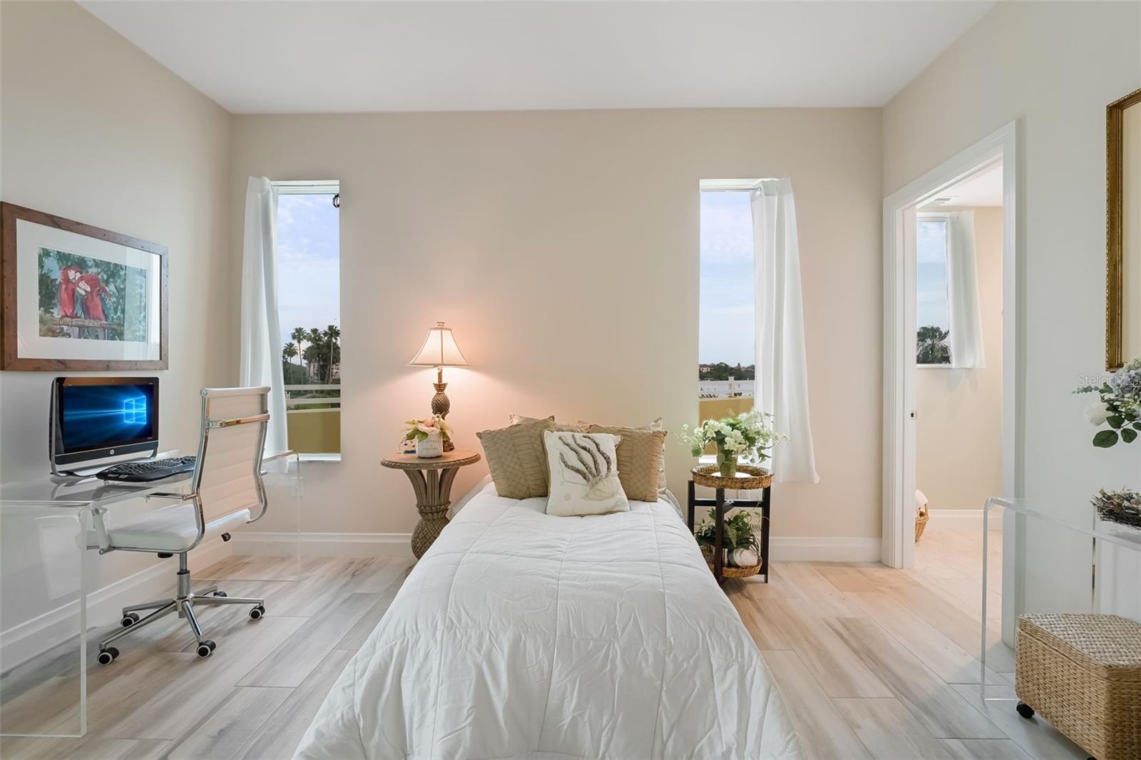 This can be a guest bedroom or office.  This bedroom has its own ensuite bathroom and sliders to the balcony.