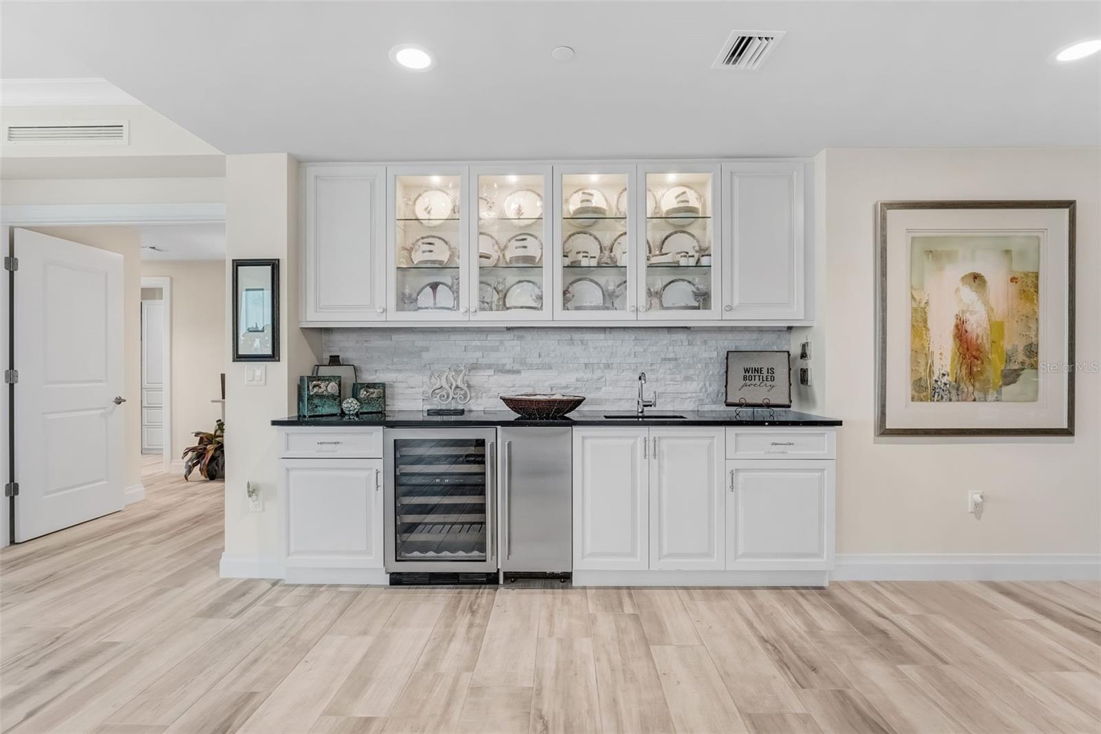 The wet bar area offers additional space for crystal & china, additional storage and beside the wine refrigerator you have an ice maker.