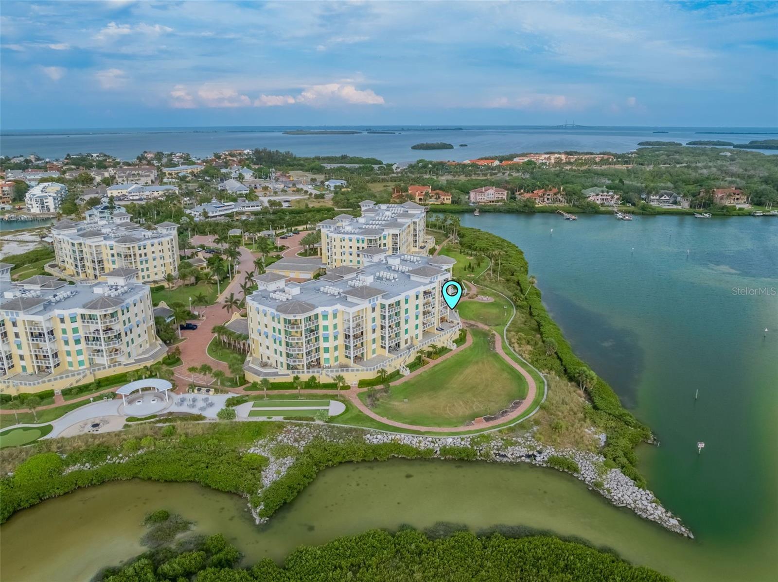 Another aerial view of the back of the building.  NOtice the walking trail around the complex & to the left notice the fire pit area and bocce ball area