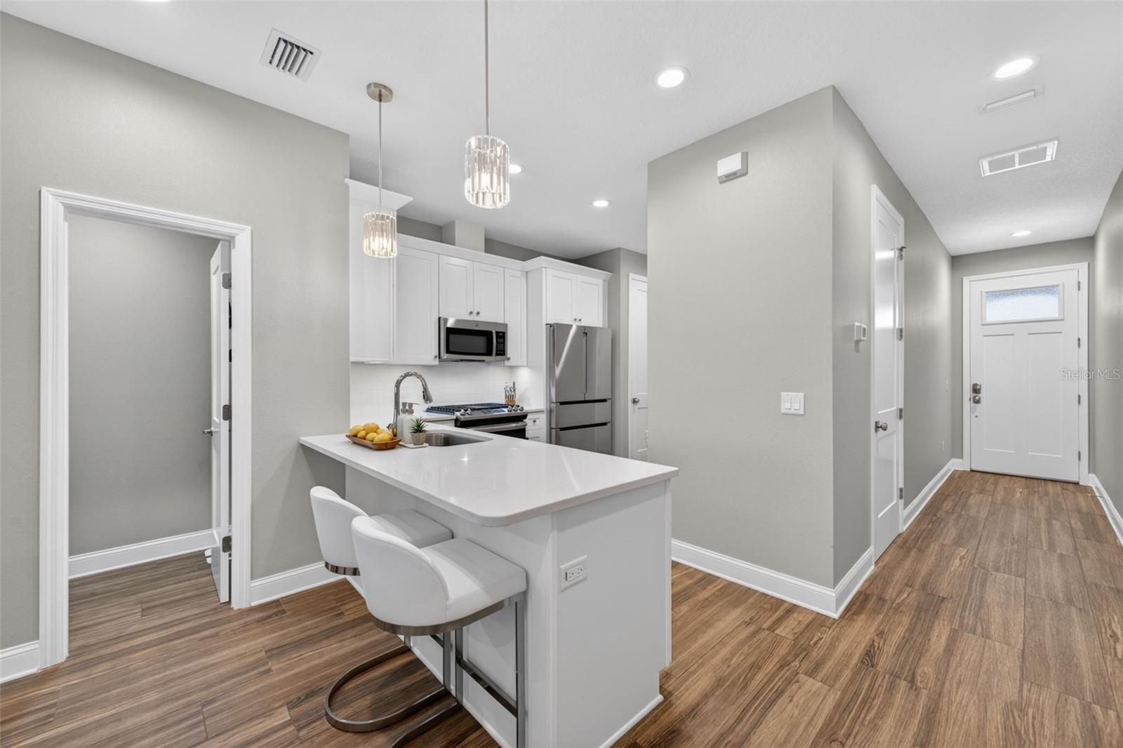 Kitchen with breakfast bar and pantry closet nearby