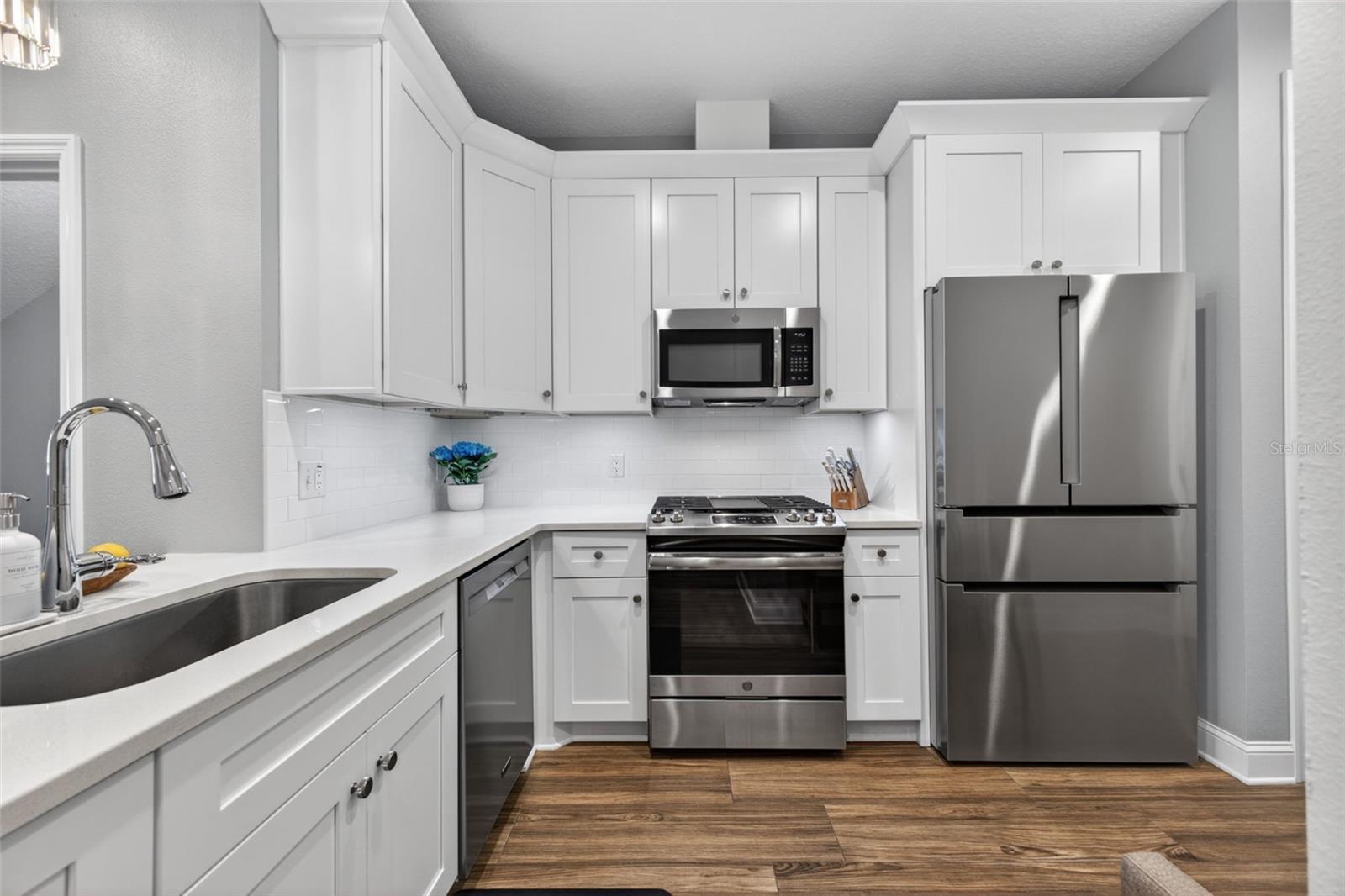 The kitchen has stone counters and all stainless steel appliances with gas 5 burner stove and center griddle and new Bosch refrigerator