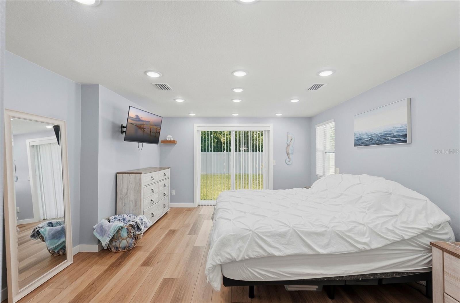 Primary bedroom w/ slider to backyard