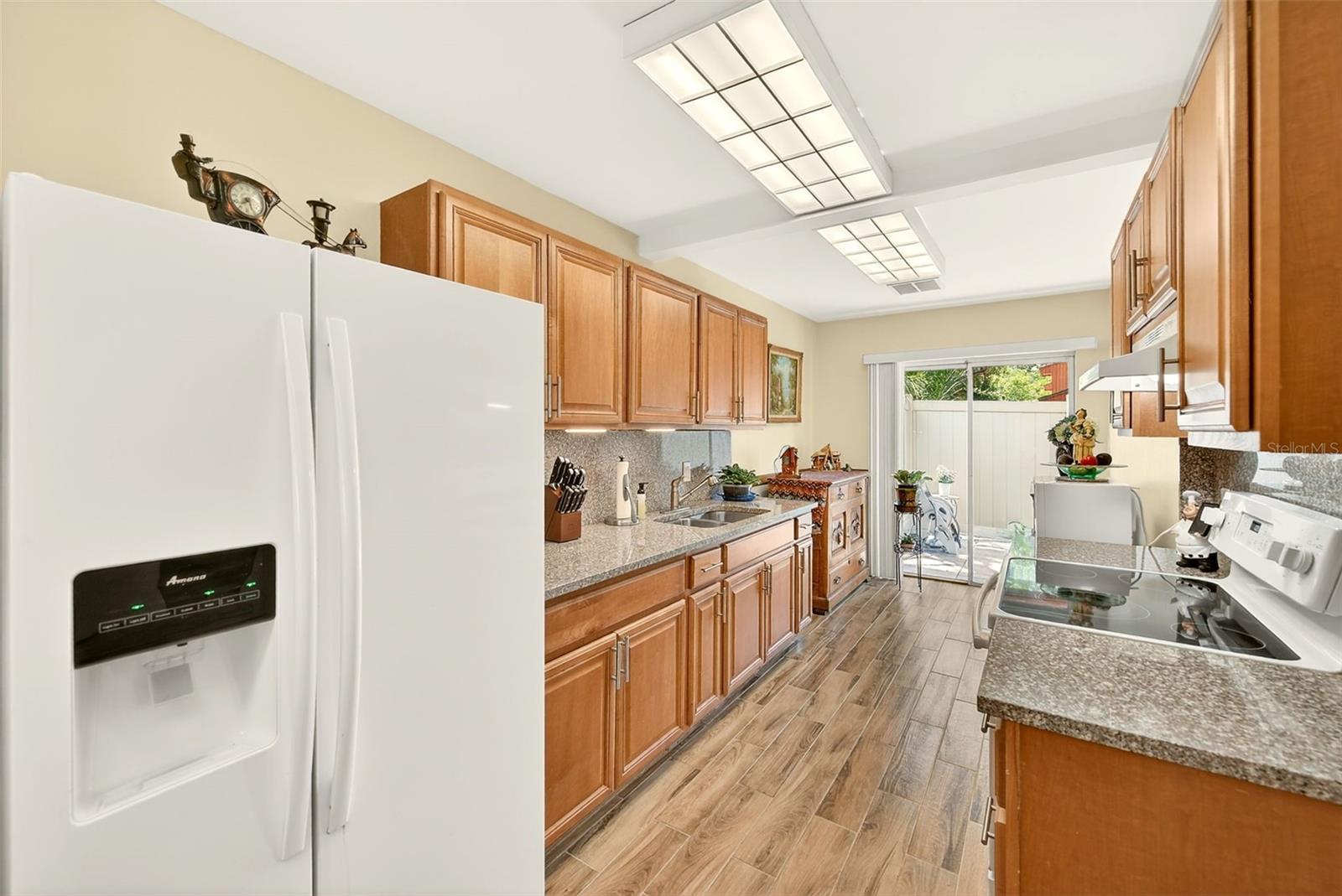 Updated kitchen has solid granite back splash