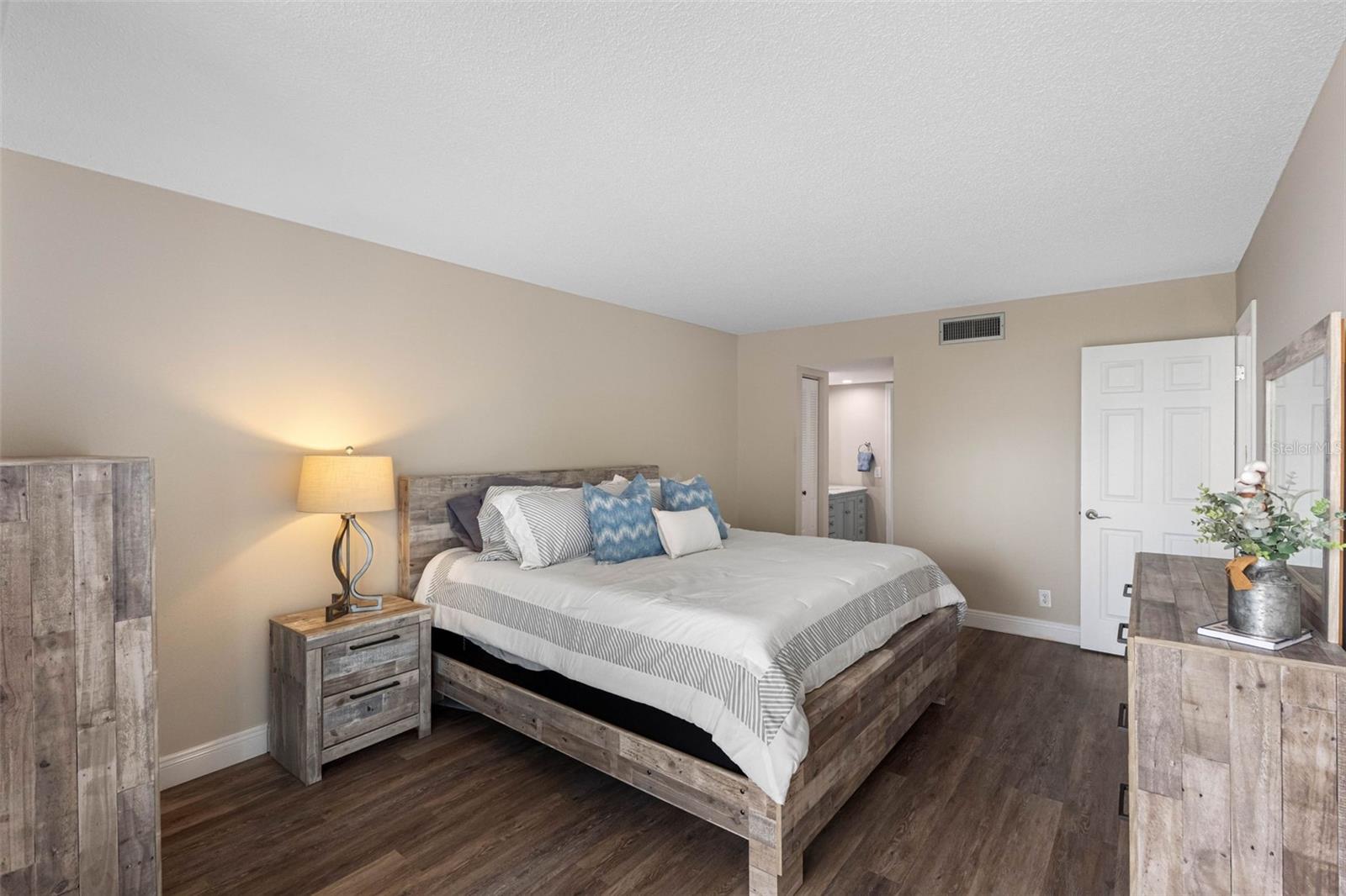 Spacious primary suite with balcony access