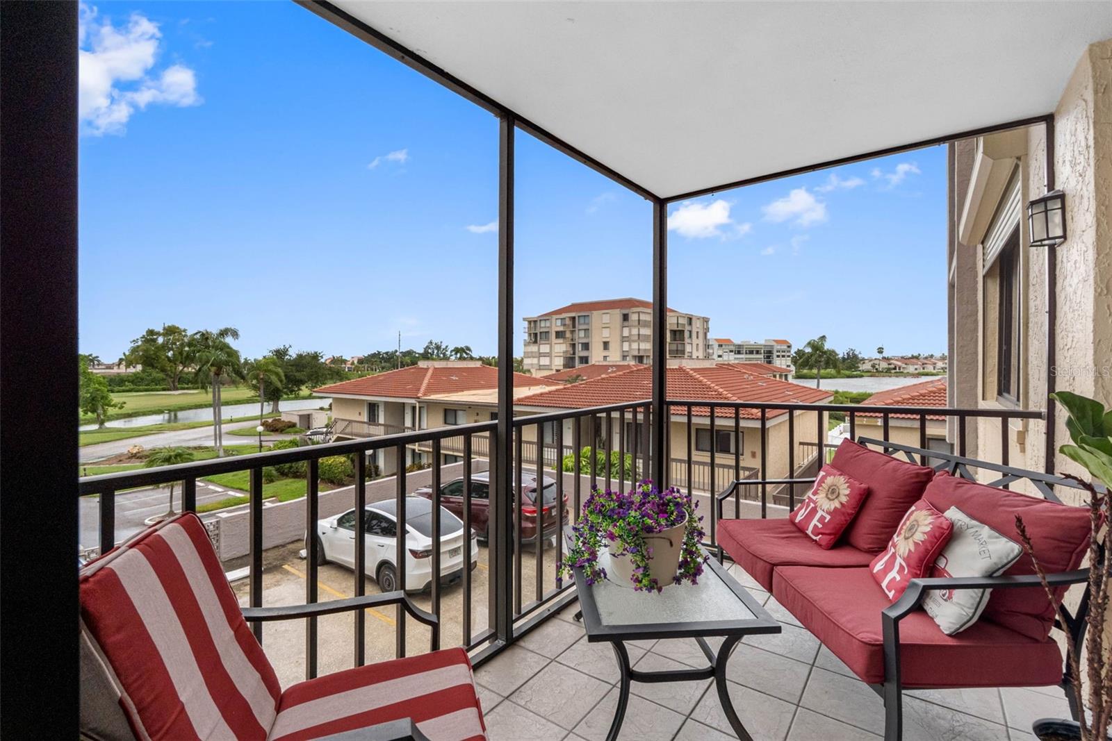 Screened balcony overlooking lush golf greens