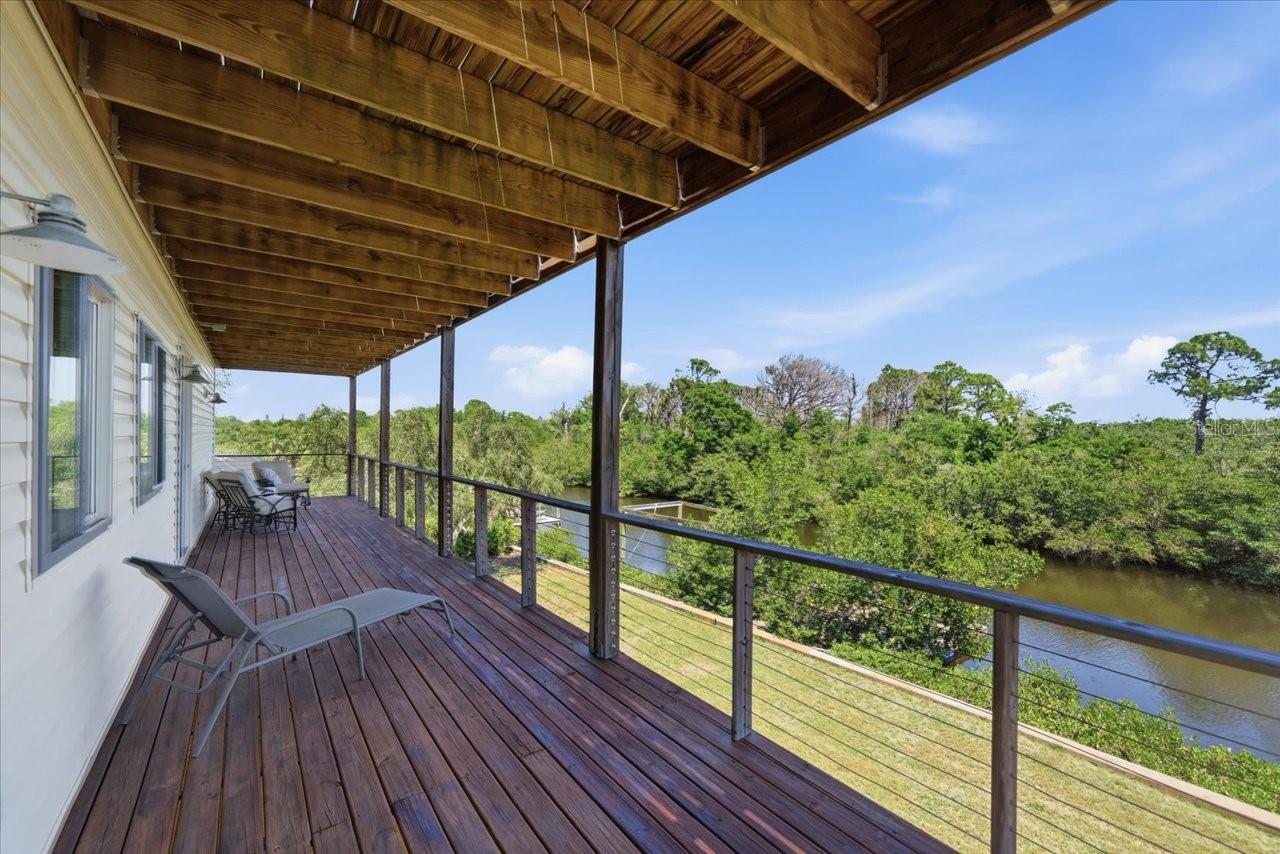Covered balcony/deck 2nd level- Primary and 3rd bedroom Access